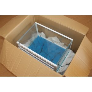 Fish tank being carefully packed in a special order box