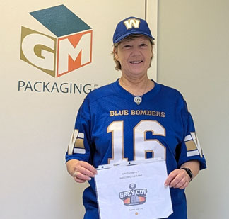 GM Packaging President Sue Goodwin gets ready for the Canadian Association of Movers show, sporting her Winnipeg Blue Bombers gear in advance of the Grey Cup