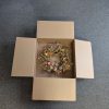 Wreath box with flaps open, with a gold, rustic style wreath inside