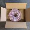 Wreath box with flaps open, with a white and lavender wreath inside