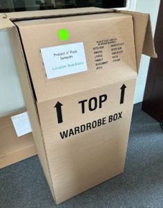 A tall wardrobe box includes 